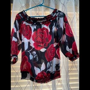 Nice blouse with large red and black flowers.
